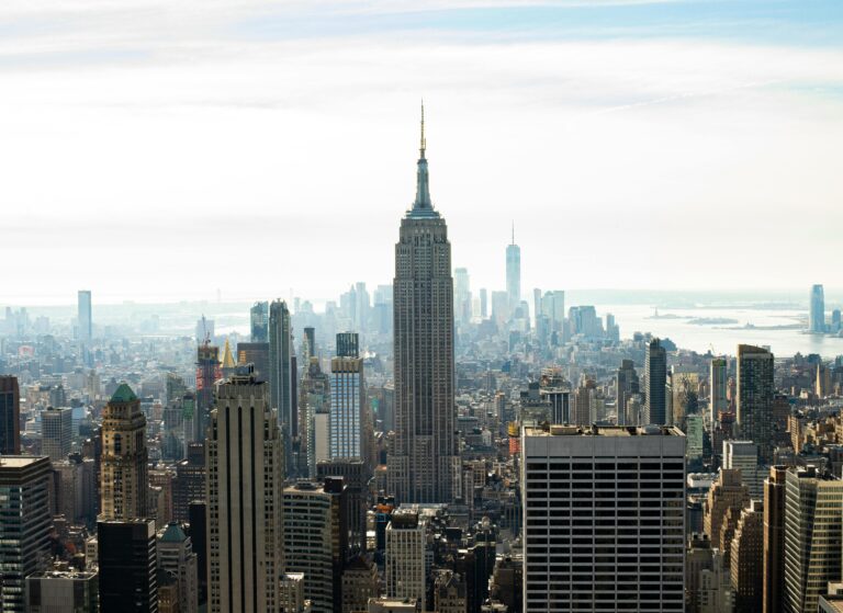 View of NYC skycrapers with Empire State Building in background, Traveling to New York City: What to Know Before You Go