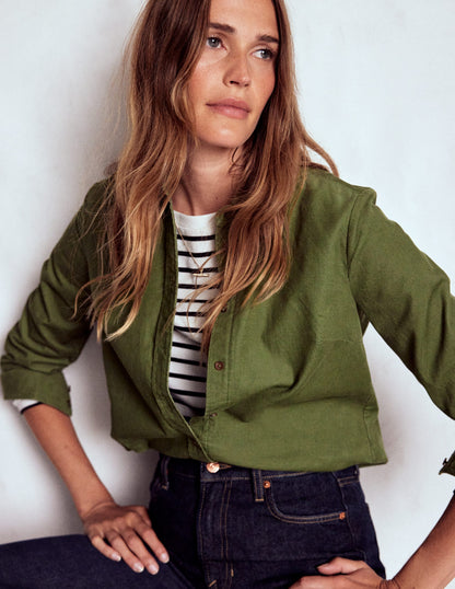 french girl style, woman wearing a striped tee with a boden sienna cord shirt in green